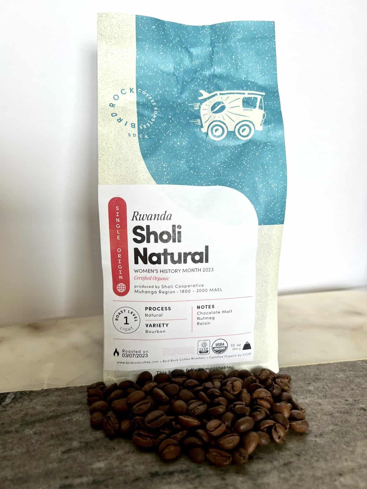 Bird Rock Coffee packaging stands on coffee beans scaled