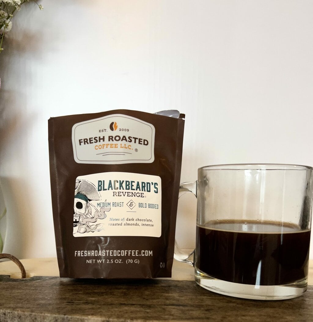 Fresh Roasted Coffee Subscription Review & Photos For 2024 27 Blackbeard's Revenge next to a cup of coffee