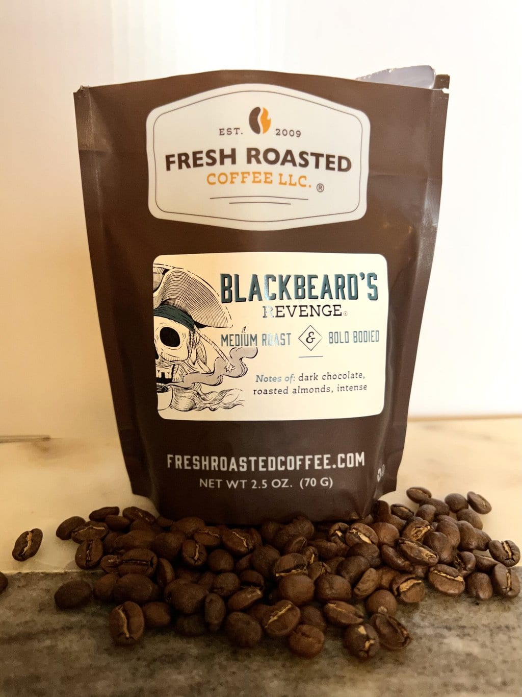 Fresh Roasted Coffee Subscription Review & Photos For 2024 26 Blackbeard's Revenge next to coffee beans