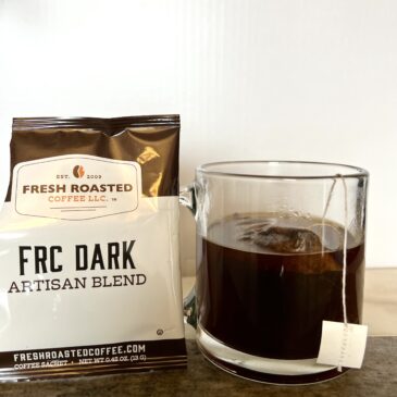 FRC Dark coffee next to the cup