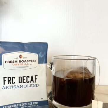 FRC Decaf Artisan blend coffee next to the cup