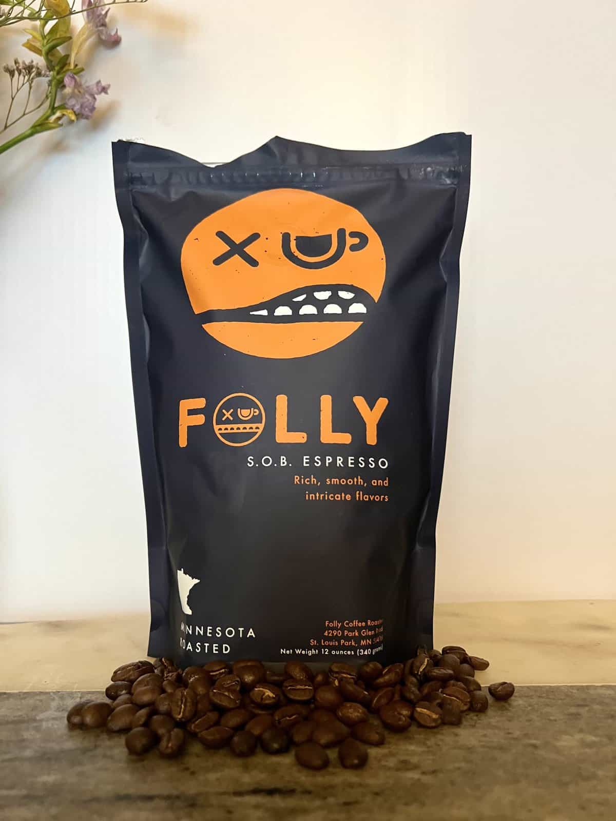 S.O.B. Espresso Folly coffee pack next to coffee beans