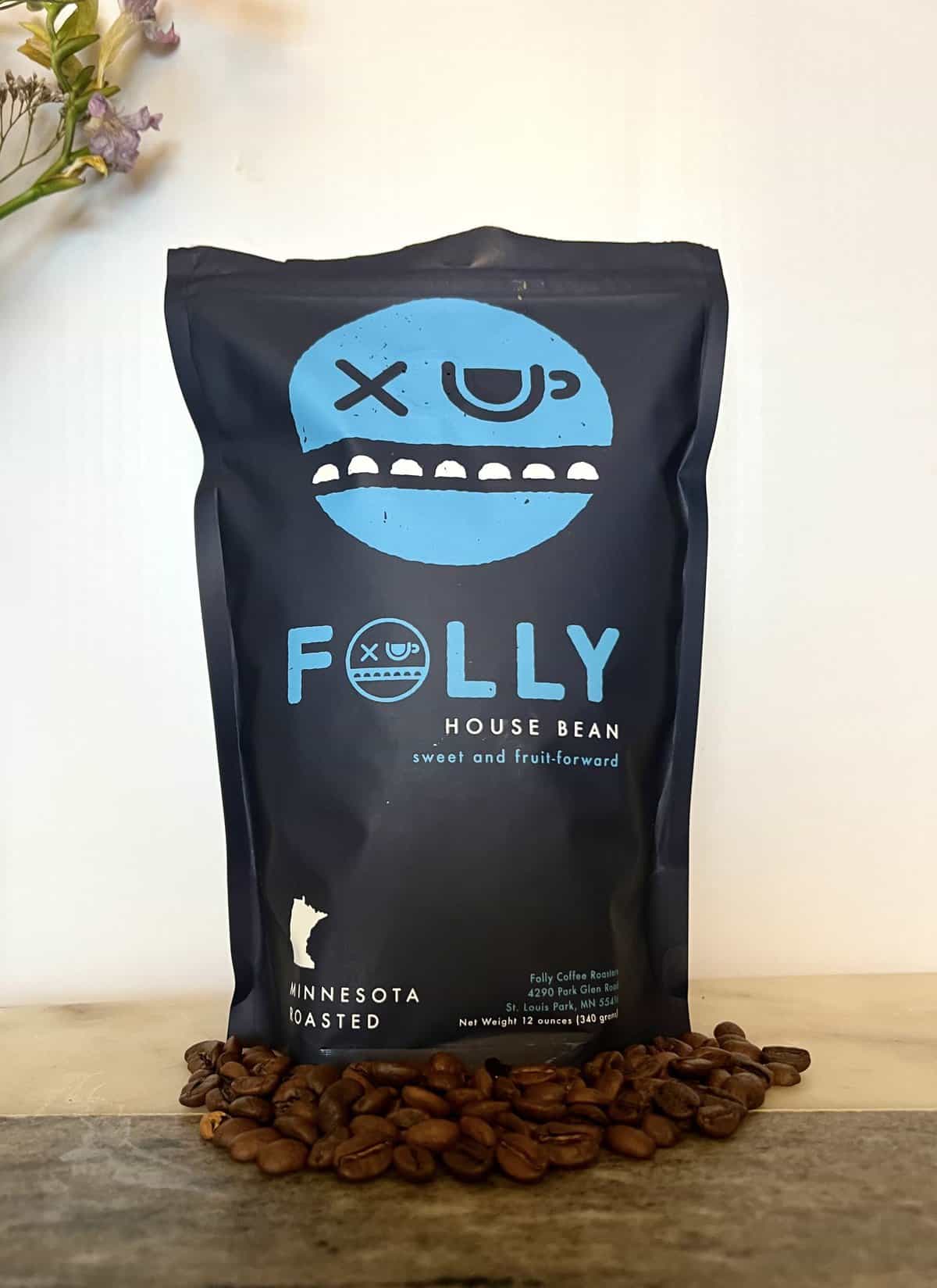 Folly Coffee Subscription Review: Quality Roasted Coffee 9 House Bean Folly Coffee pack next to coffee beans