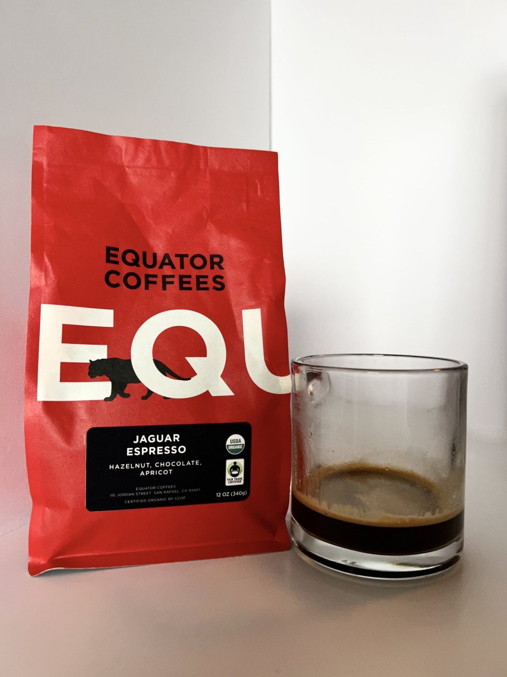 Jaguar Espresso Fair Trade Organic next to a brewed cup of coffee