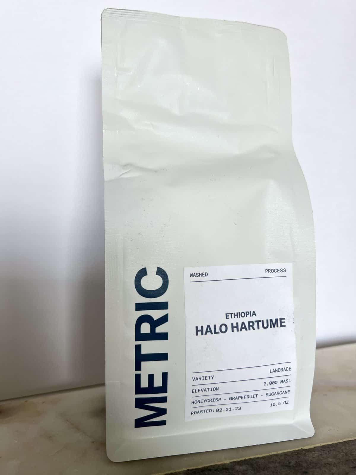 Fellow Coffee Subscription Review: Deliveries Designed To Educate 7 Metric-Coffee-packaging-stands-on-coffee-beans-scale