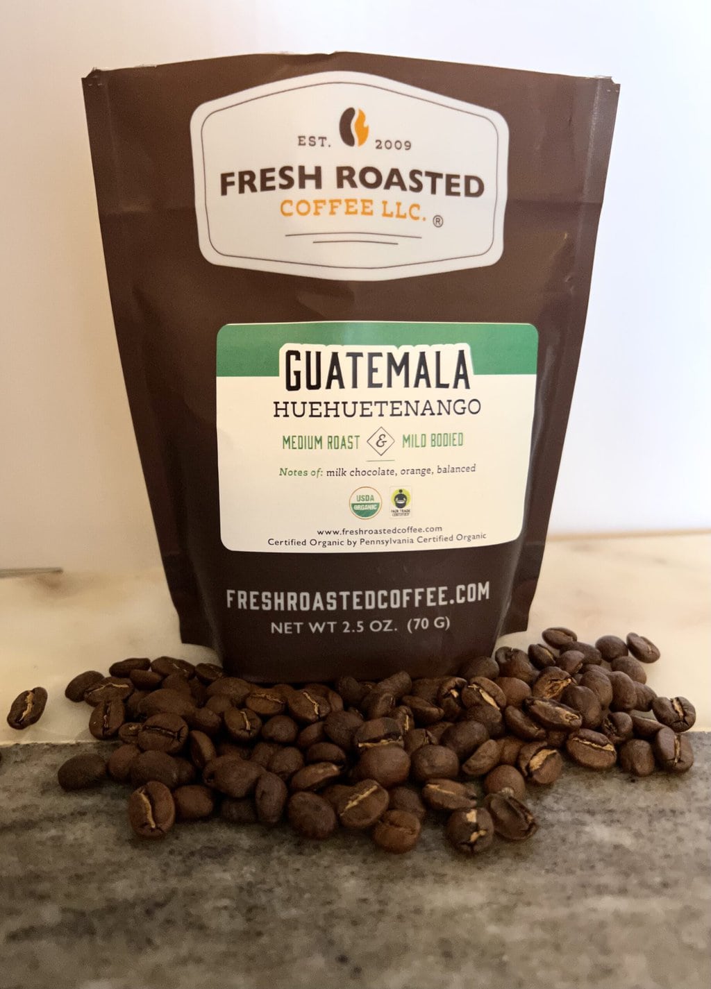Fresh Roasted Coffee Subscription Review & Photos For 2024 18 Organic Guatemala Huehuetenango next to coffee beans