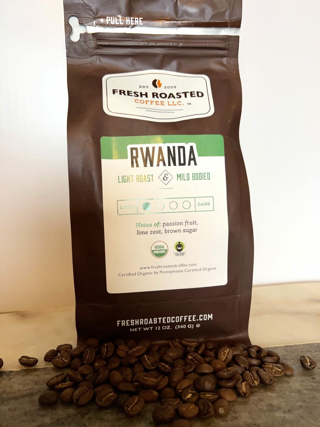 Fresh Roasted Coffee Subscription Review & Photos For 2024 34 Organic Rwanda next to coffee beans