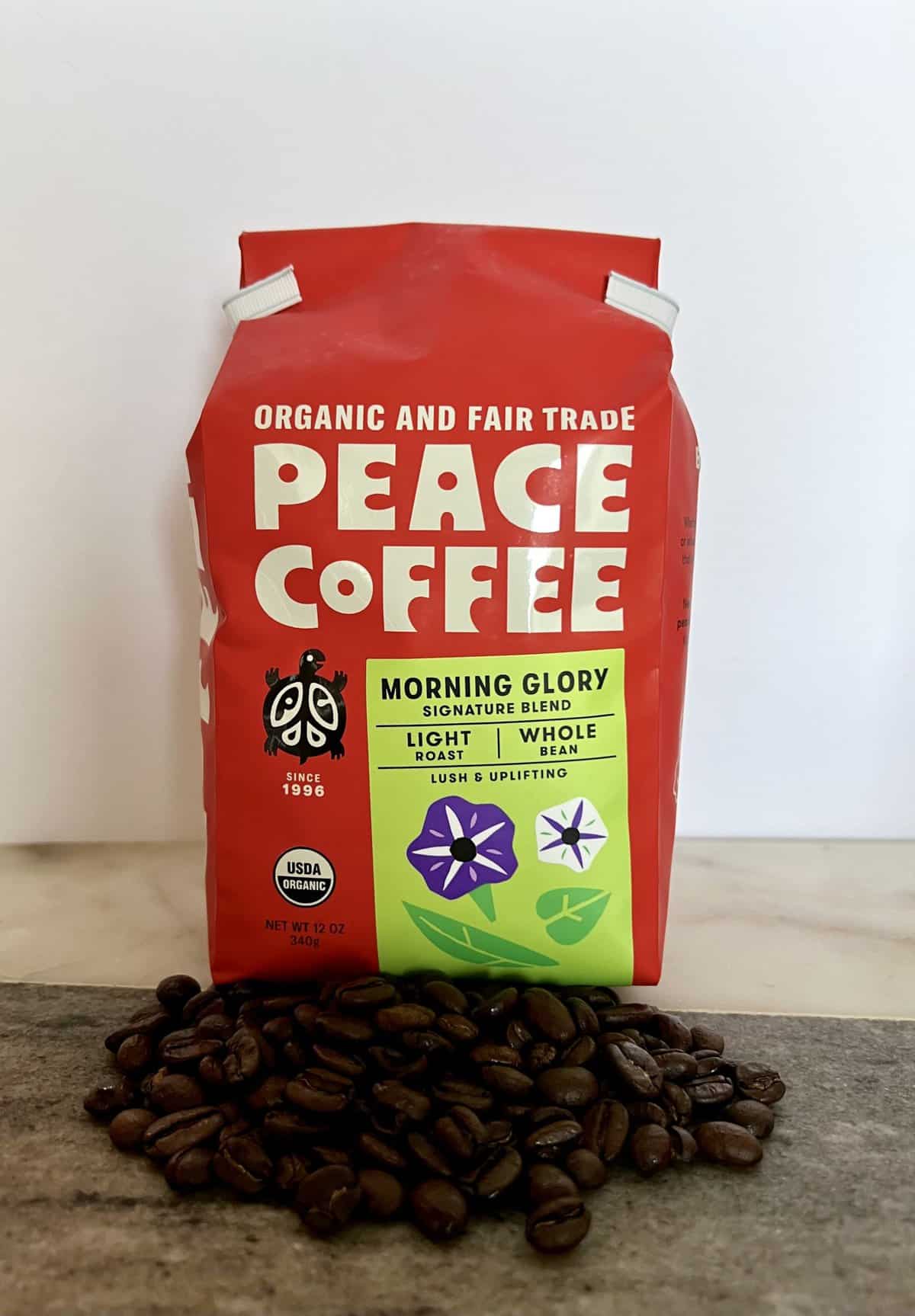 Peace Coffee Review: Our Take on This Fair Trade Coffee 15 Peace Coffee Morning Glory pack next to the coffee beans