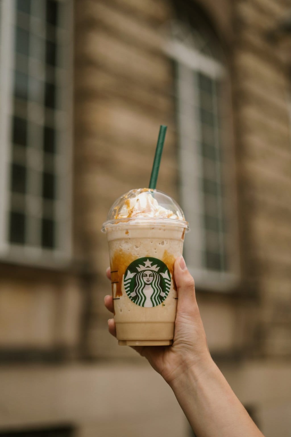 Person Holding Starbucks Cup with Frappuccino drink