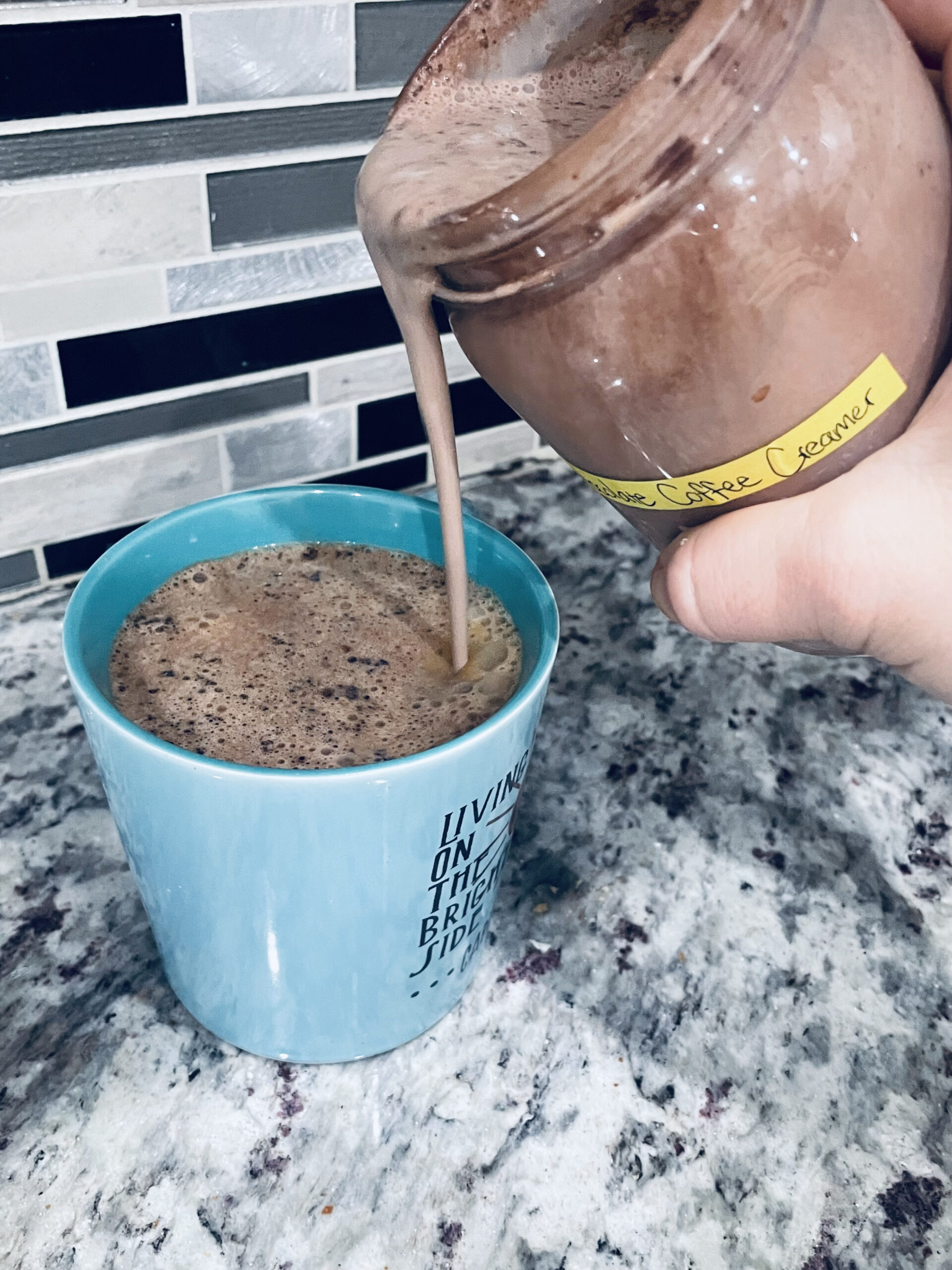 Pouring Chocolate Coffee Creamer into a cup of coffee