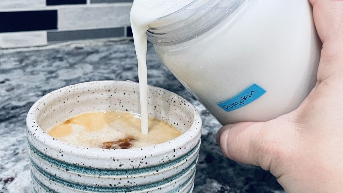 Pouring creamer into coffee