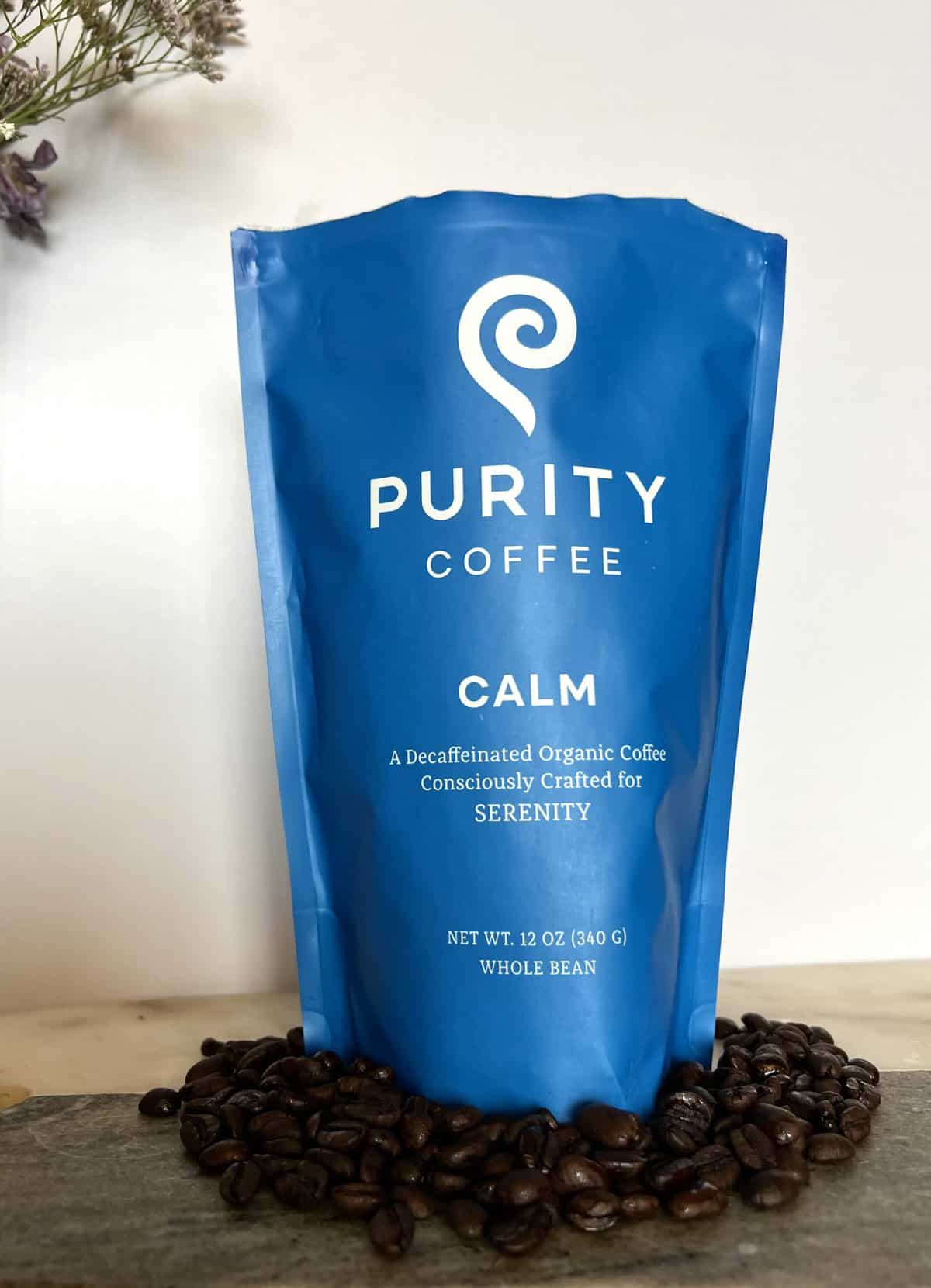 Purity Coffee Review: Healthy & Organic Beans 6 Purity Coffee CALM next to coffee beans