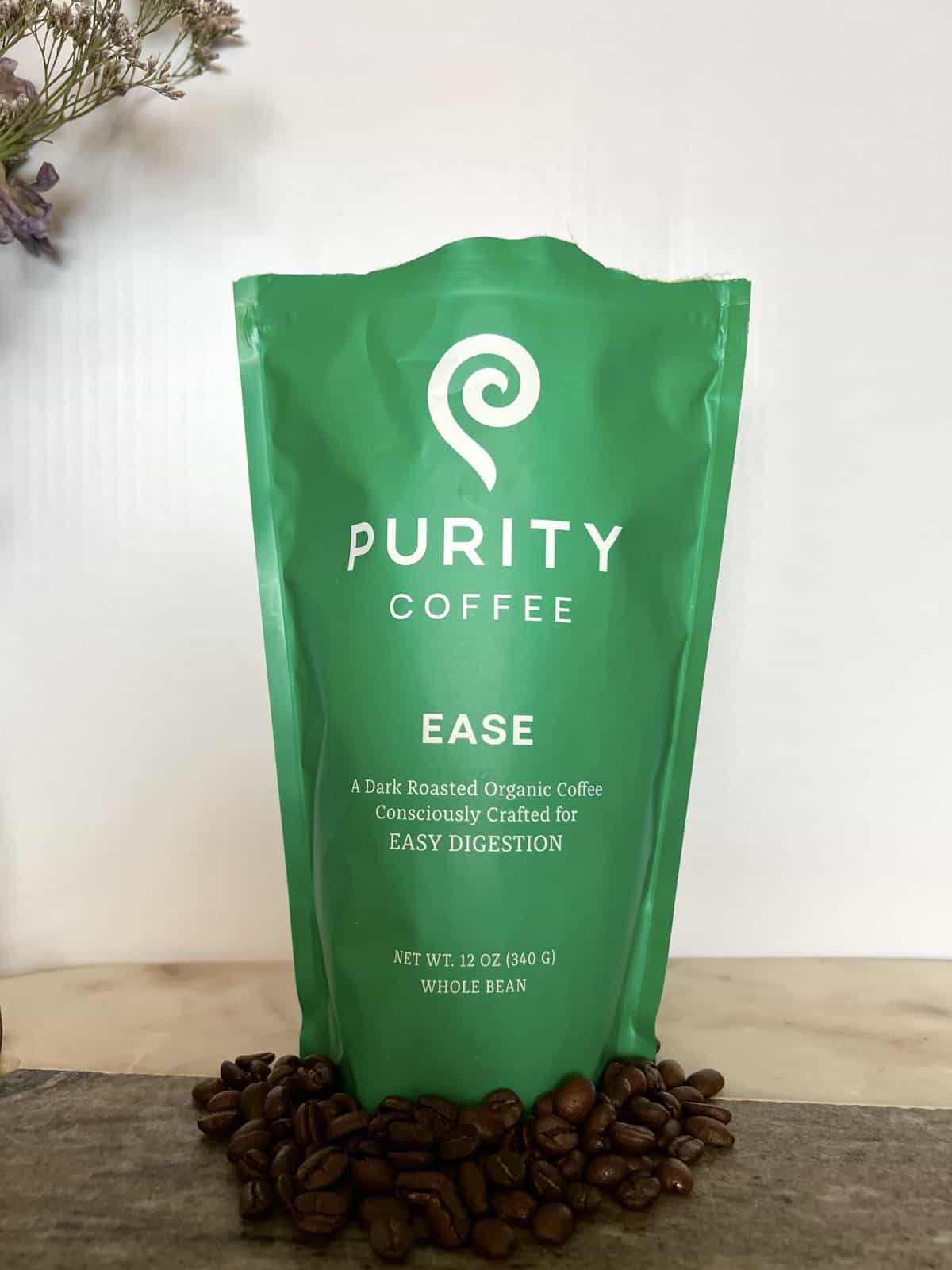 Purity Coffee Review: Healthy & Organic Beans 13 Purity Coffee EASE next to coffee beans