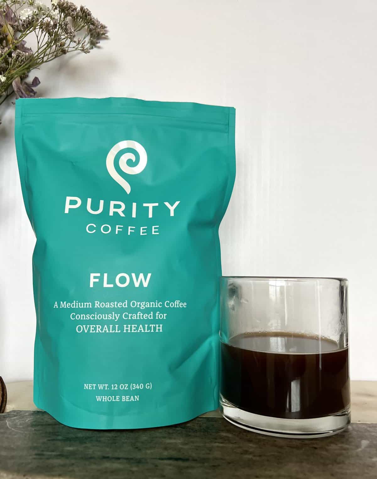 Purity Coffee Review: Healthy & Organic Beans 11 Purity Coffee FLOW next to the cup