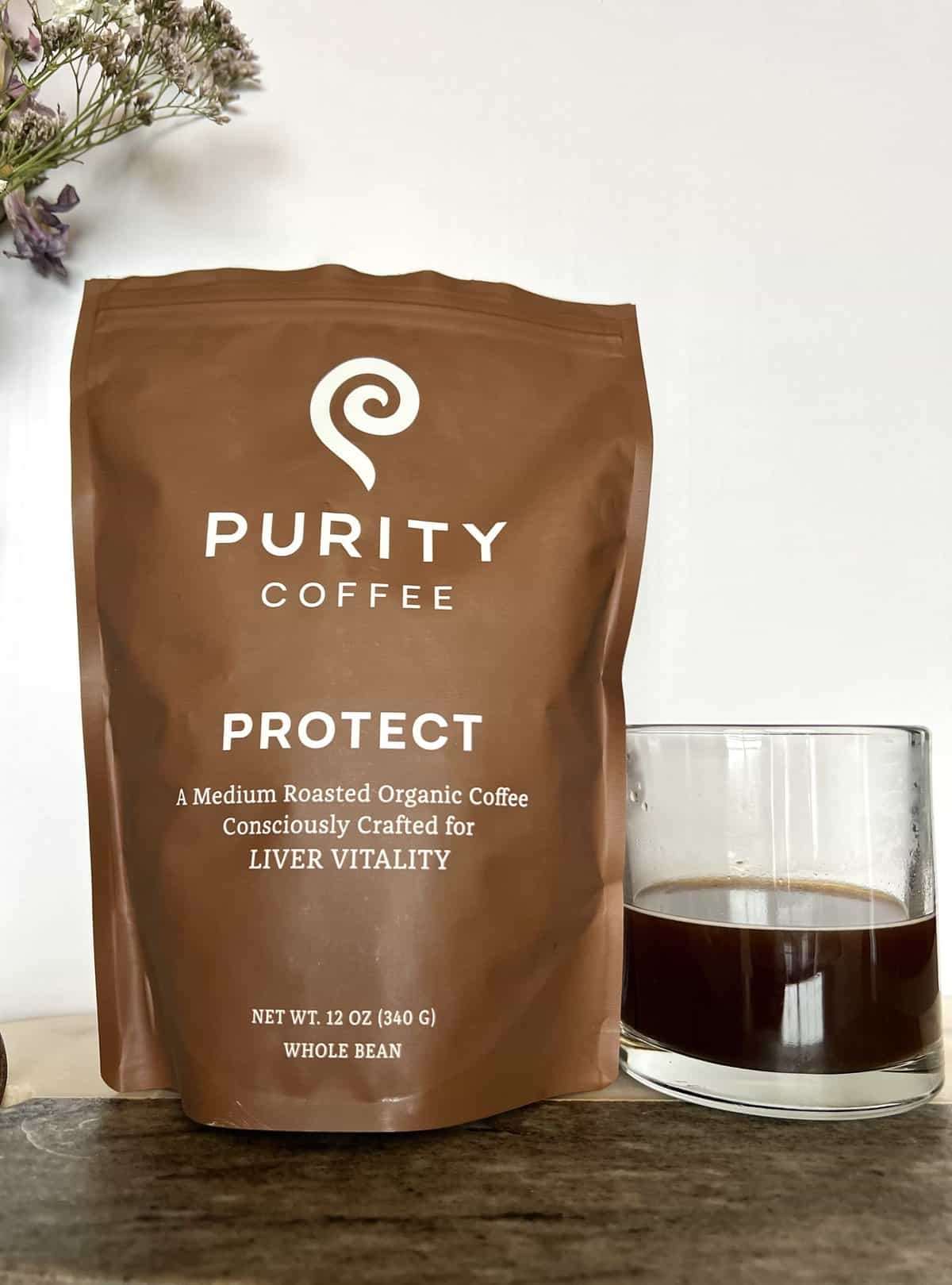 Purity Coffee Review: Healthy & Organic Beans 5 Purity Coffee EASE next to coffee beans