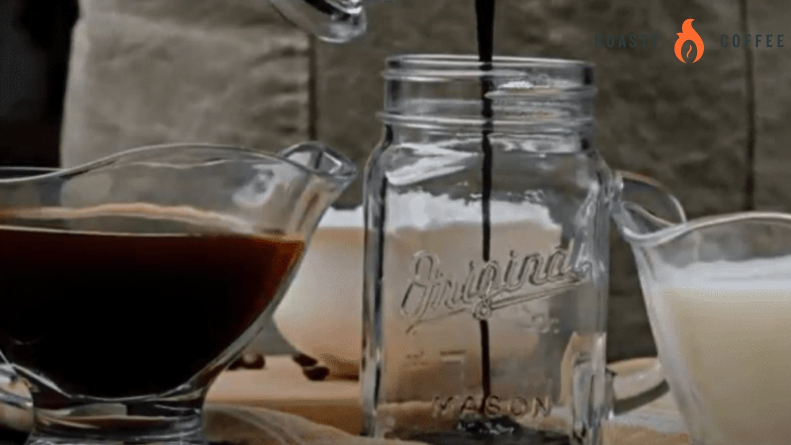 Ditch the Line: This Iced Mocha Recipe Is Better Than the Pros 3 Squirting a chocolate sauce into a mason jar