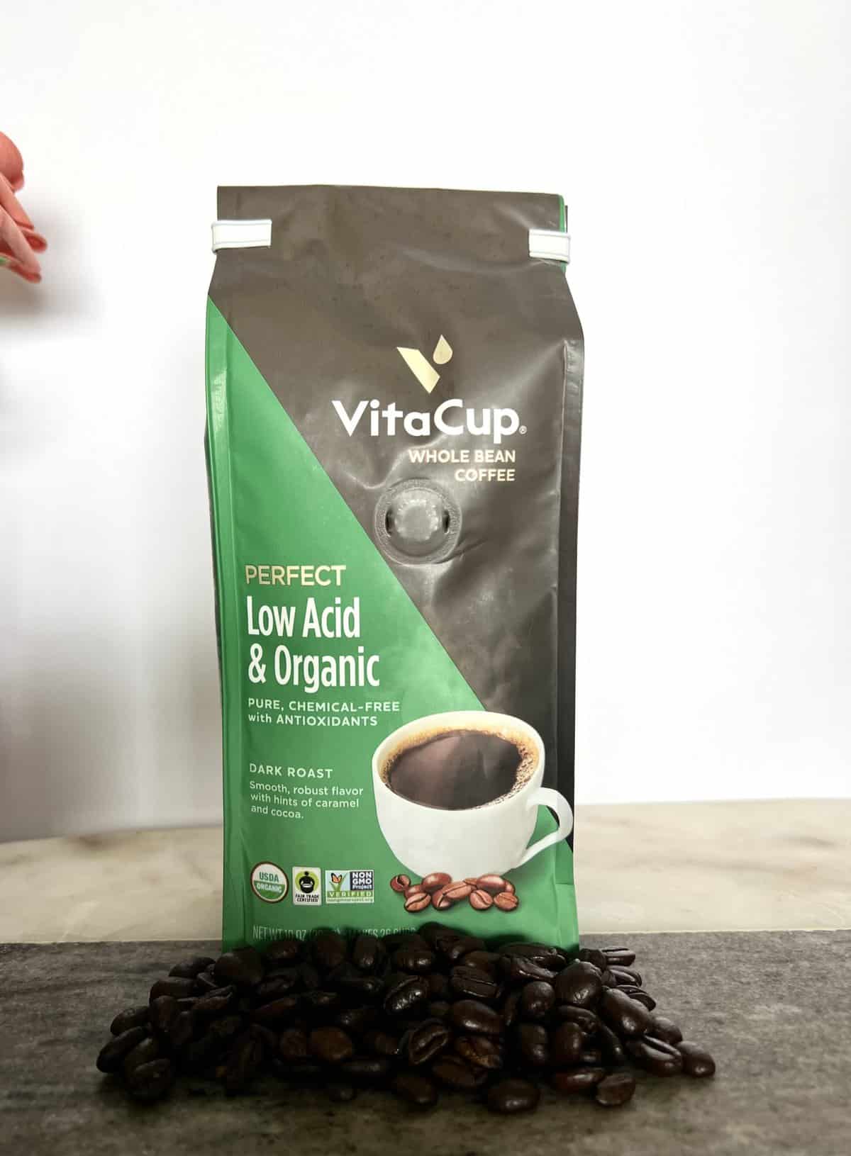 VitaCup-Perfect-Low-Acid-Coffee-Beans-Coffee-stands-on-coffee-beans-scaled