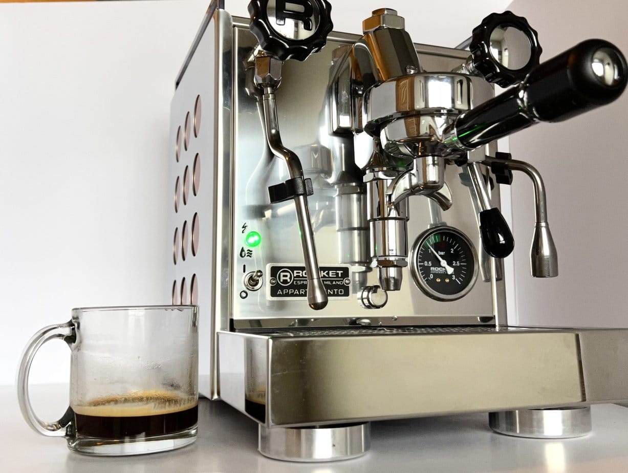 a cup of espresso on the side of the Rocket Espresso Appartamento coffee machine