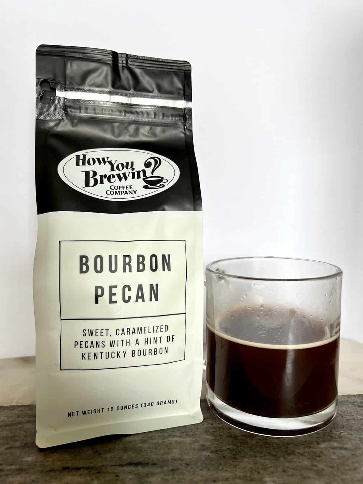 How You Brewin Coffee Subscription Review: Flavorful Brews 13 a-package-of-Bourbon-Pecan-coffee-stands-next-to-a-brewed-cup-of-coffee-scaled