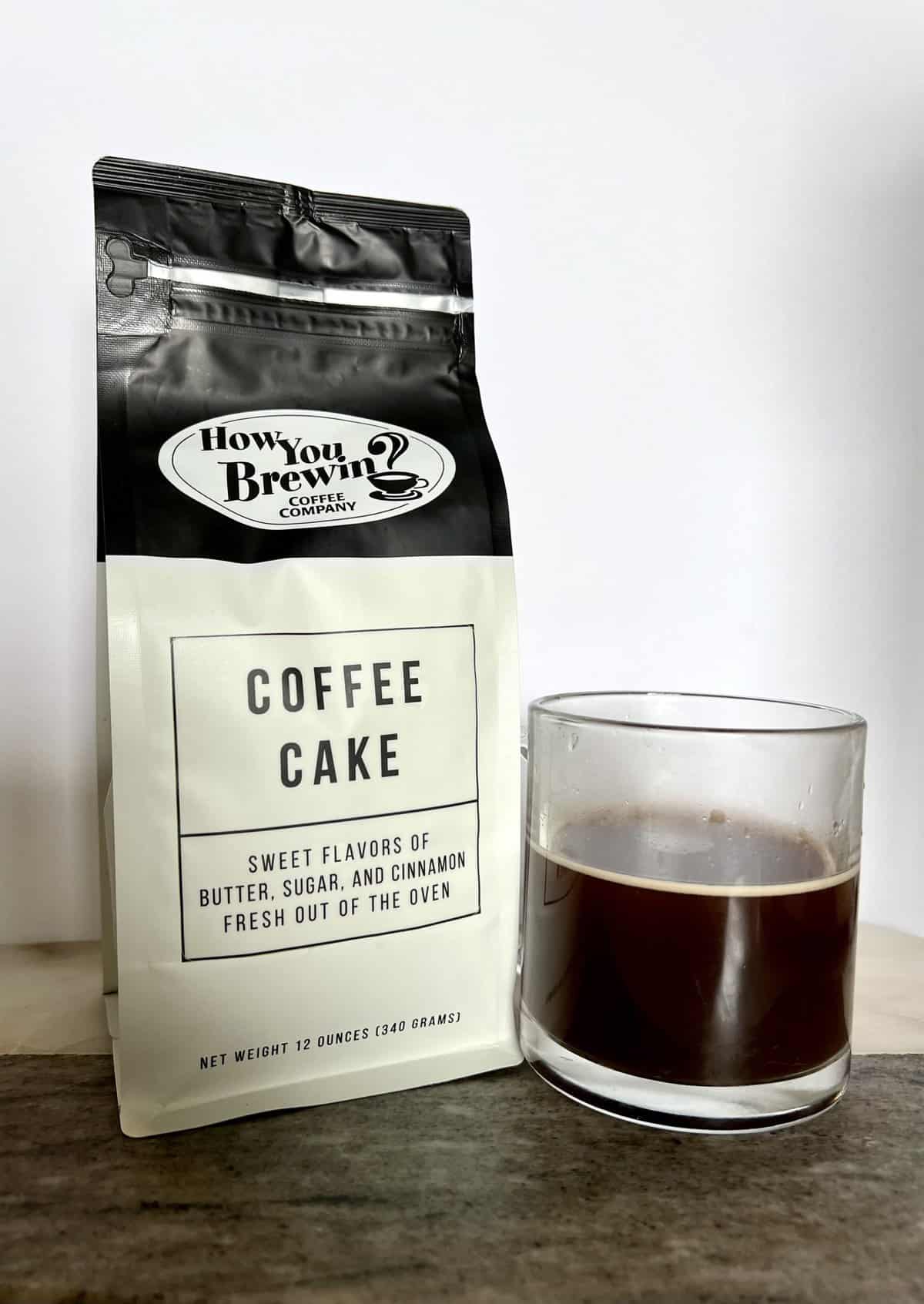 How You Brewin Coffee Subscription Review: Flavorful Brews 16 a-package-of-Coffee-Cake-coffee-stands-next-to-a-brewed-cup-of-coffee-scaled