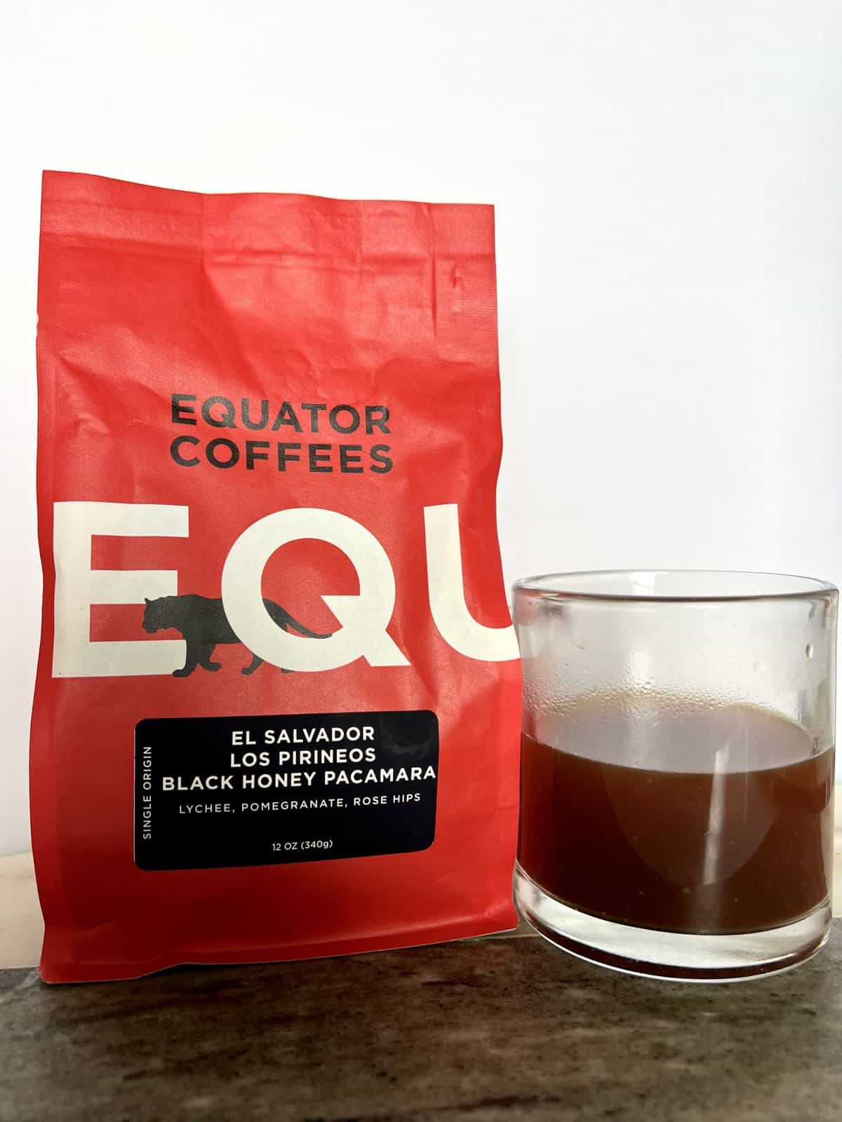 Fellow Coffee Subscription Review: Deliveries Designed To Educate 5 a package of Equator Coffee stands next to a brewed cup of coffee scaled 1