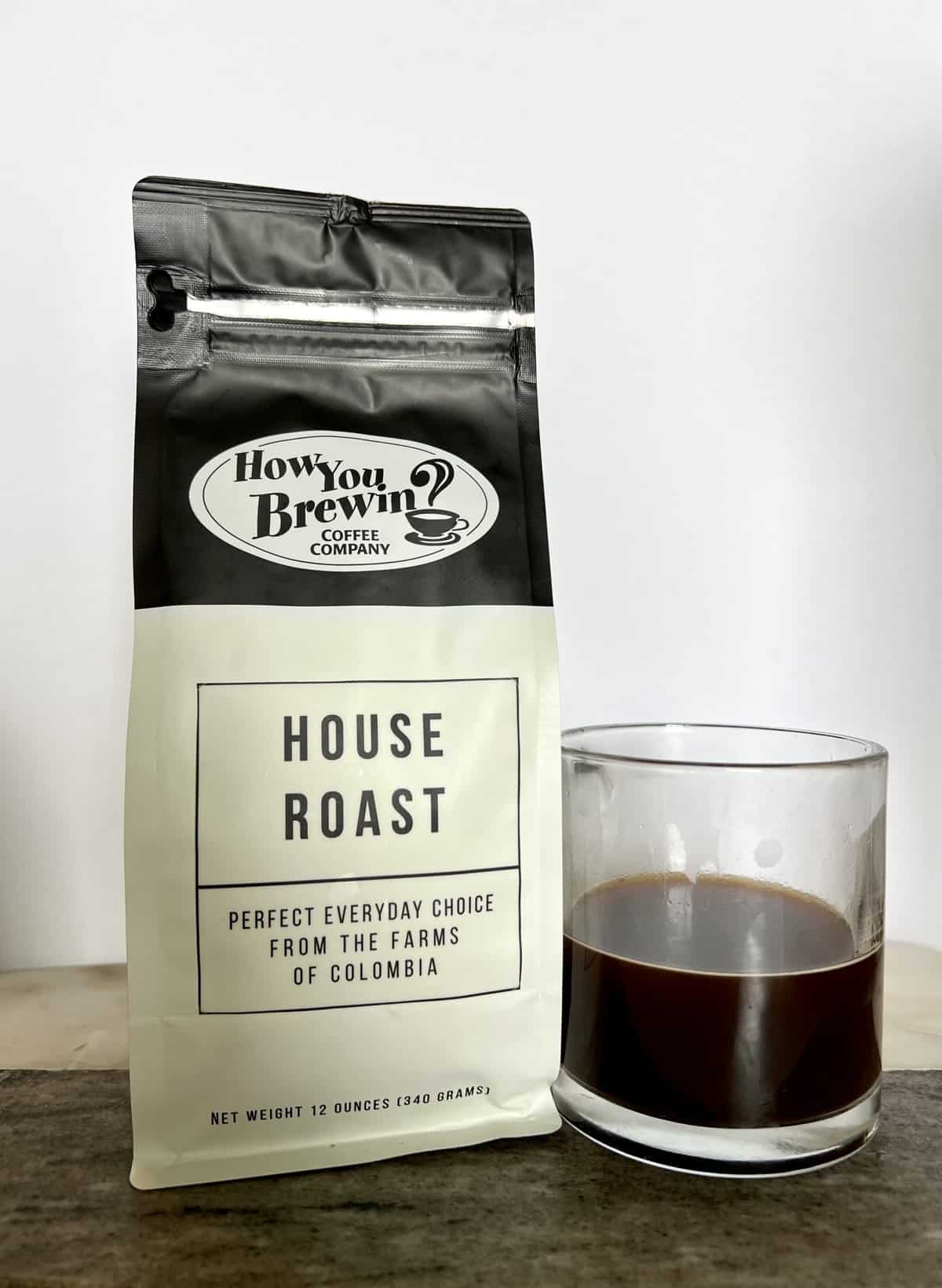 How You Brewin Coffee Subscription Review: Flavorful Brews 7 a-package-of-House-Roast-coffee-stands-next-to-a-brewed-cup-of-coffee-scaled