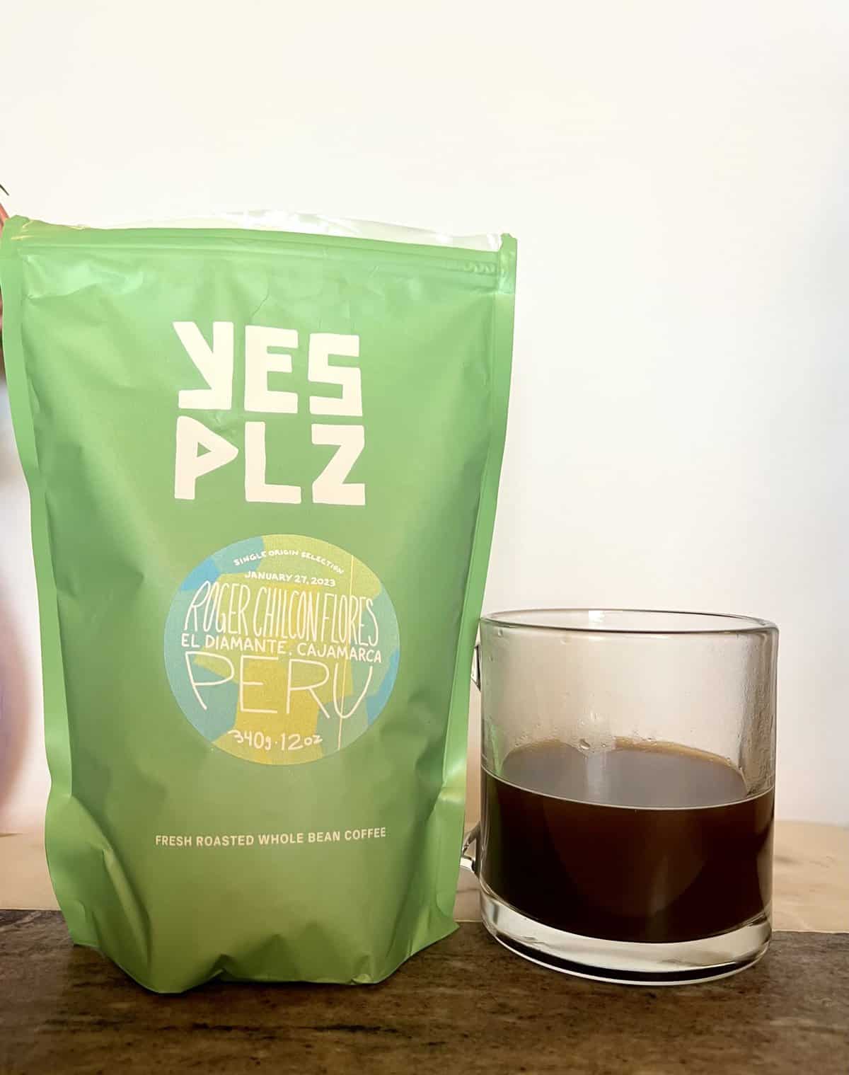 Yes Plz Coffee Review: Roasting Outside The Box 18 Yes Plz package of Single Origin Roger Chilcon Flores coffee stands next to a cup of brewed coffee