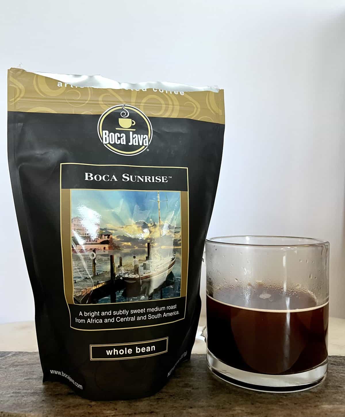 Boca Java Subscription Review: Specialty Flavored Coffees 6 an-open-package-of-Boca-Sunrise-coffee-stands-next-to-a-cup-of-brewed-coffee-scaled
