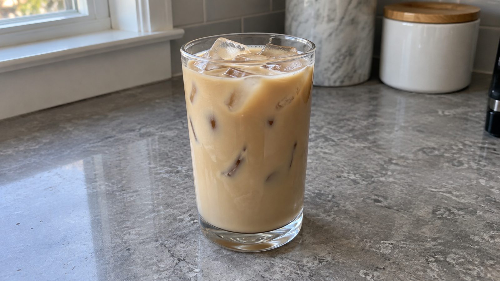 7 Homemade 7 Brew-Inspired Coffee Drinks 10 Cinnamon Roll-Inspired White Chocolate Breve in a clear glass on a kitchen counter