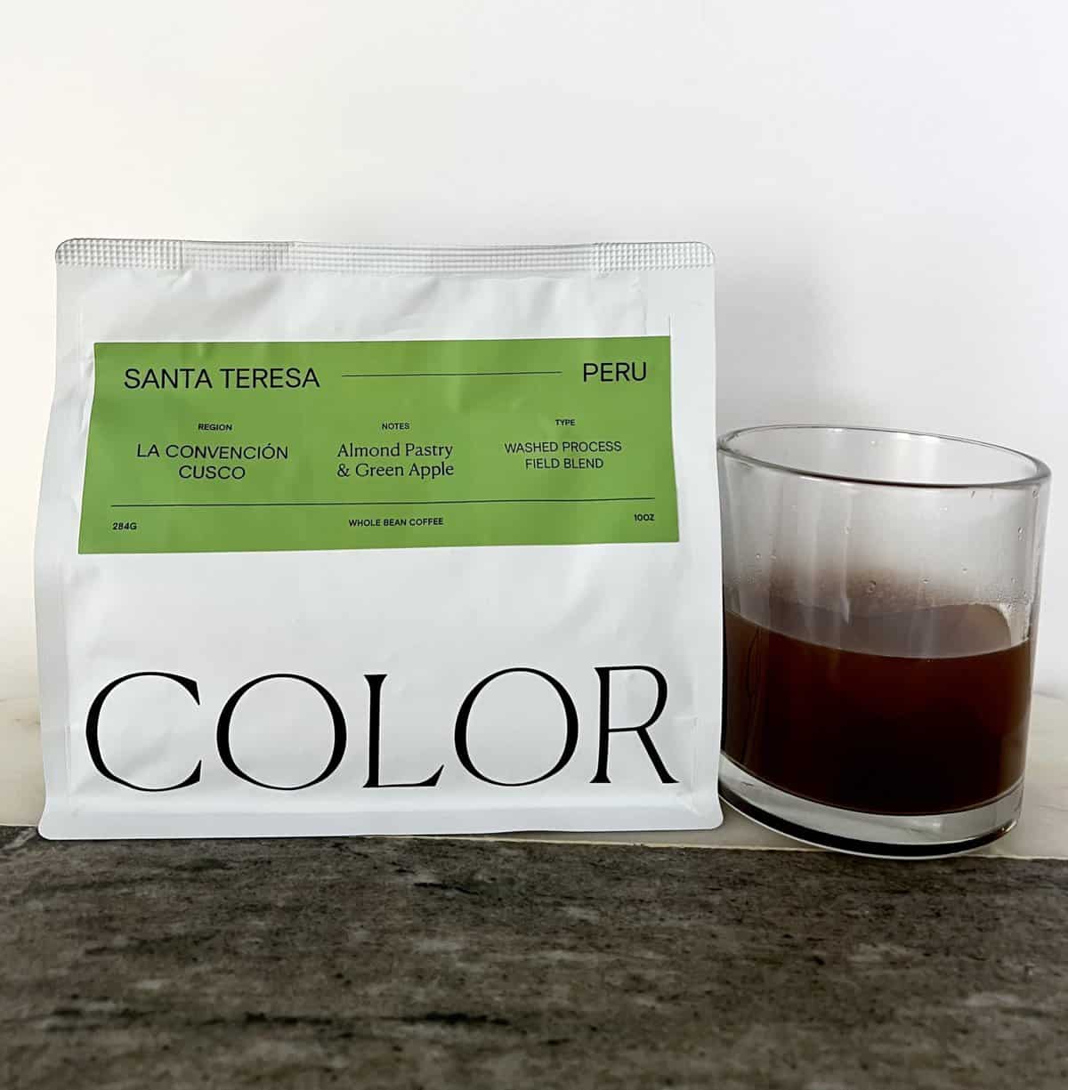 Color Coffee Roasters Subscription Review: Taste the Rainbow 8 packaging-Santa-Teresa-Peru-coffee-stands-next-to-a-cup-of-brewed-coffee-scaled