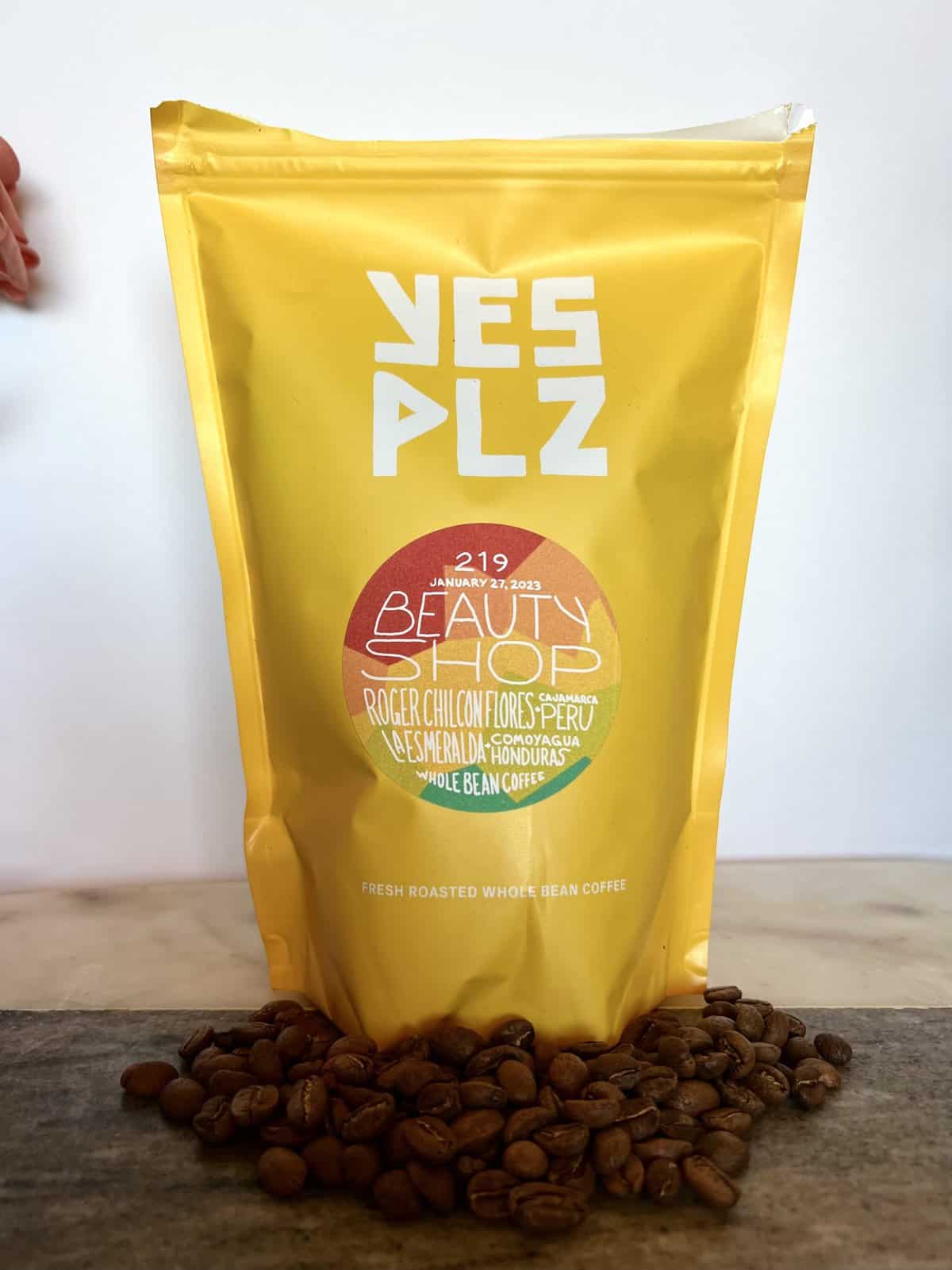 Yes Plz Coffee Review: Roasting Outside The Box 17 Yes Plz packaging of The Mix 219 "Beauty Shop" coffee stands on coffee beans