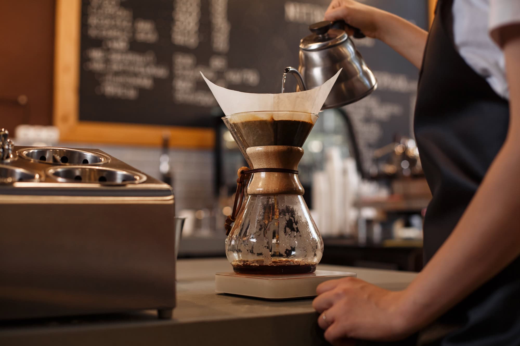 The Best Coffee Brewing Method For Every Zodiac Sign 10 Professional barista preparing coffee using chemex pour over coffee maker and drip kettle.