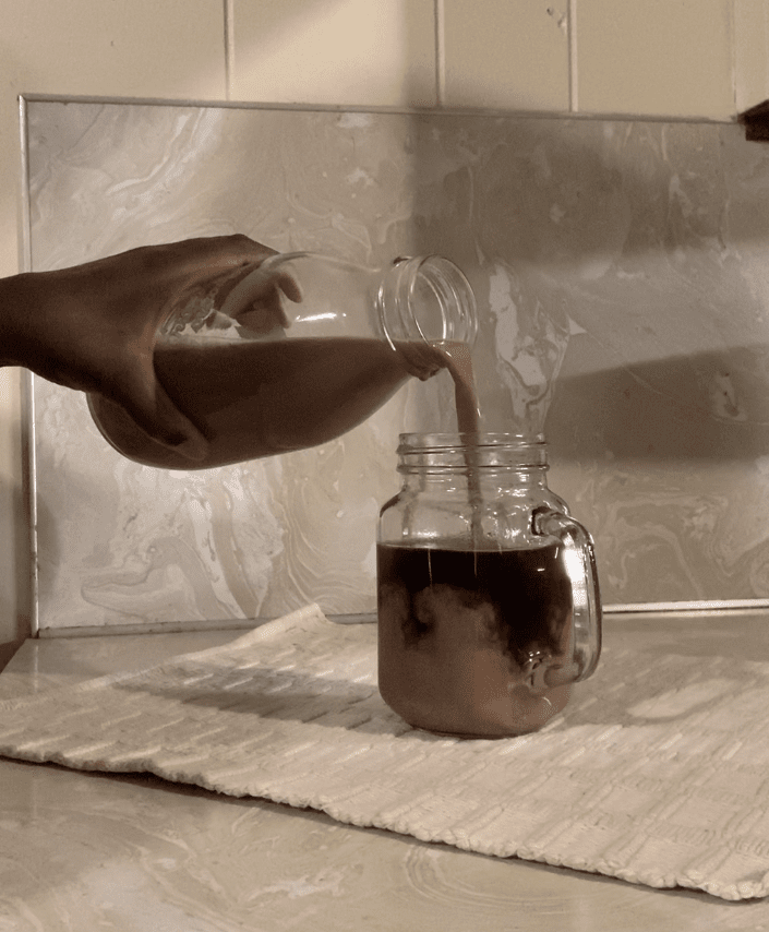 pouring Irish Cream Coffee Creamer into the cup of coffee