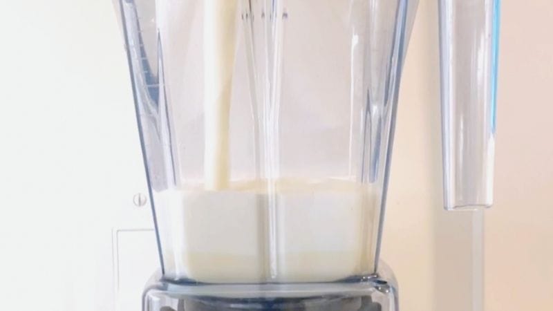 pouring a cup of frothy foam into a blender 