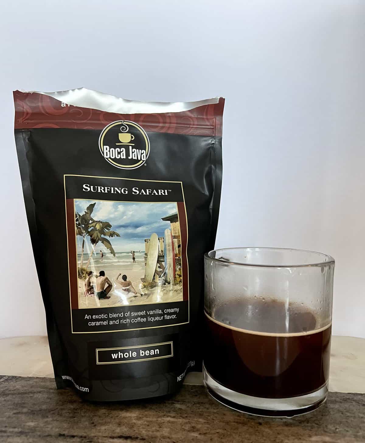 Boca Java Subscription Review: Specialty Flavored Coffees 10 the-open-side-of-a-Surfing-Safari-coffee-package-stands-next-to-a-cup-of-brewed-coffee-scaled